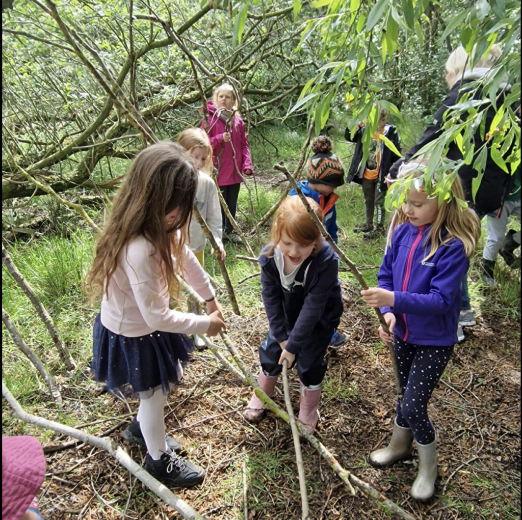 Children exploring the Havannah Nature Reserve and den building whilst at Playtime Paradise summer holiday club.